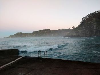 Scenic view of sea against clear sky during sunset