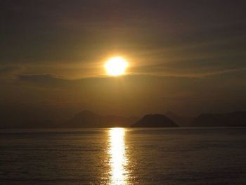 Reflection of clouds in sea at sunset