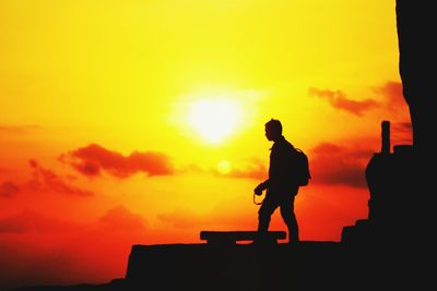 Silhouette man against sky during sunset