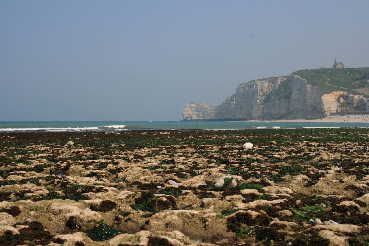 sea, water, clear sky, scenics, horizon over water, copy space, beach, rock - object, beauty in nature, tranquil scene, tranquility, shore, nature, rock formation, sky, idyllic, coastline, rock, cliff, stone - object