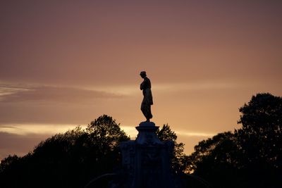 Low angle view of statue against sky during sunset