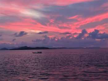 Scenic view of sea against dramatic sky during sunset