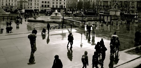 High angle view of people walking on water in city