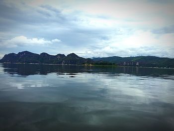 Scenic view of lake against cloudy sky