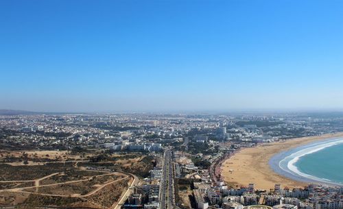 High angle view of cityscape against clear blue sky
