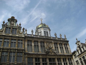 Low angle view of building against cloudy sky