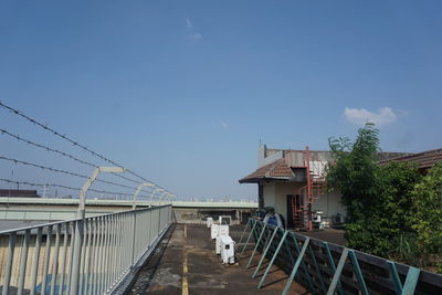 Bridge over buildings in city against sky