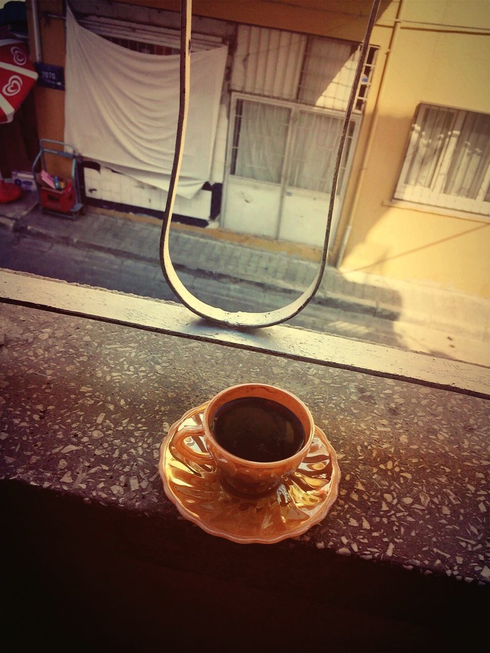 building exterior, architecture, built structure, close-up, sunlight, day, no people, metal, drink, outdoors, shadow, still life, window, table, street, railing, high angle view, house, coffee cup