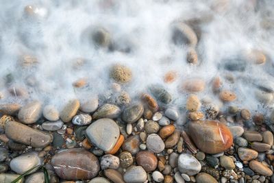 Directly above shot of surf at rocky shore