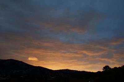 Scenic view of mountains against cloudy sky