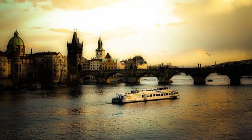 Boats in river with city in background