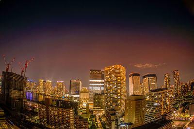 High angle view of illuminated buildings in city at night