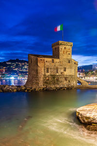 Night view of the ancient castle built on the bay of rapallo on the italian riviera