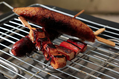 Close-up of meat cooking on barbecue grill