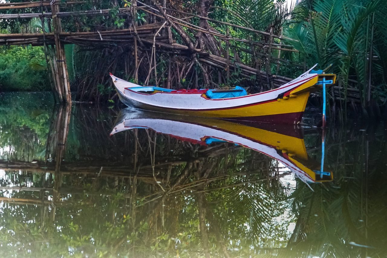 BOATS MOORED ON LAKE