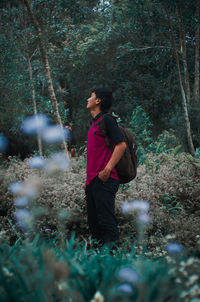 Man looking away in forest