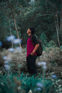 Full length of young man looking at forest