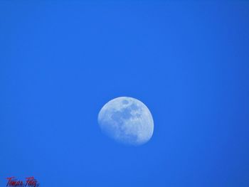 Close-up of crystal ball against blue sky