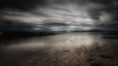 Scenic view of sea against storm clouds