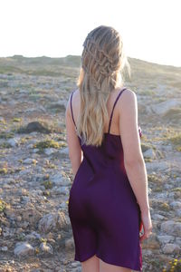 Rear view of woman standing against sky