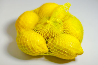 Close-up of yellow fruit against white background