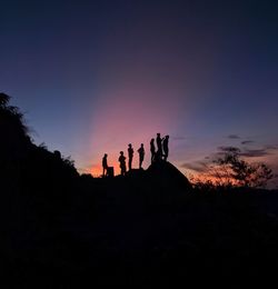 Silhouette people against sky during sunset