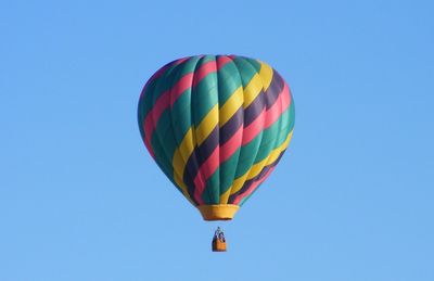 Low angle view of hot air balloon against clear sky on sunny day