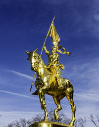 Low angle view of statue against blue sky