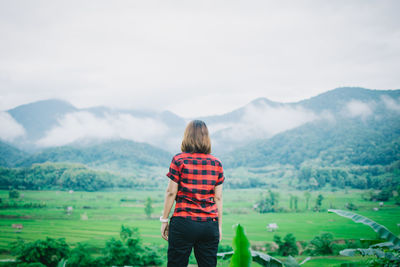 Rear view of man standing on mountain