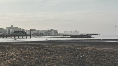 View of sea and buildings against sky