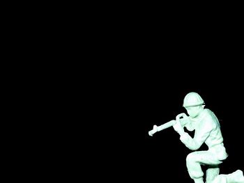 Illuminated flying over black background