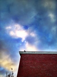 Low angle view of building against cloudy sky