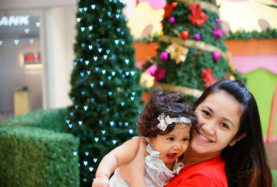 Close-up of baby girl with christmas tree