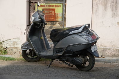 Side view of motor scooter parked on street