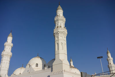 Low angle view of mosque against clear blue sky