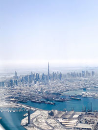 High angle view of buildings by sea against sky