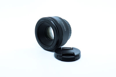 Close-up of camera lens against white background