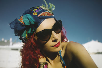 Portrait of woman wearing sunglasses against sky