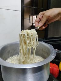 Midsection of person preparing food in kitchen