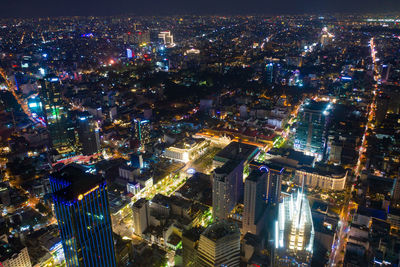 High angle view of city lit up at night