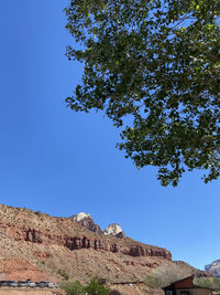 Low angle view of rock formation against clear blue sky