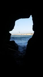 Scenic view of sea against sky seen through arch