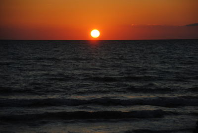 Scenic view of sea against orange sky