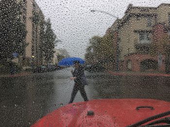 Close-up of wet car window in rainy season