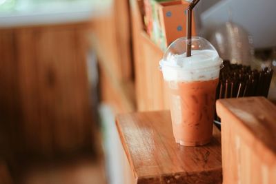 Thai milk tea on wooden table