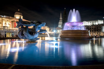 Illuminated buildings in city at night