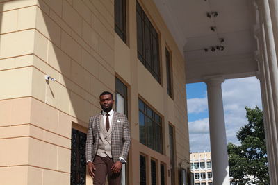 Businessman standing outside building