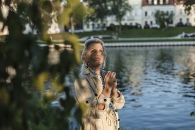 Portrait of smiling woman standing in water