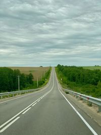 Empty road along countryside landscape