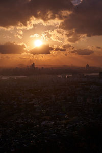 Silhouette buildings against sky during sunset
